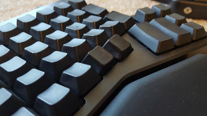 Two lower row, inner most key caps reversed so that they can be used by the thumb